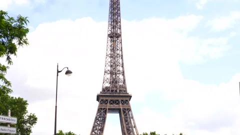 Eiffel Tower with signposts, traffic light and street lamp , Paris, France Stock Footage 260700137