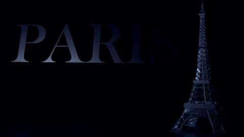 The Eiffel Tower stands tall with word Paris against a black background Stock Footage 260788162