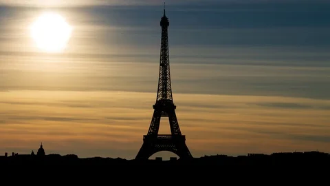 The Eiffel Tower at Sunset in Time Lapse with Sun and Orange Clouds. Paris Stock Footage 101512425