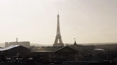 Eiffel tower view with rooftops and steam during golden hour Slow Motion Stock Footage 171174059