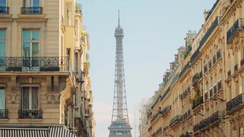 The Eiffel Tower viewed between rows of classic Parisian buildings Video stock 313412159