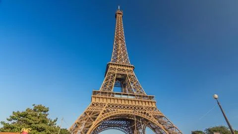 The Eiffel tower with warm light during sunset timelapse hyperlapse. Stock Photos
