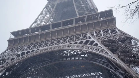 Eiffel Tower in Winter with Snow in Paris France on a snowy day Stock Footage