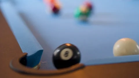 Eight Ball Sinks Into Corner Pocket on Blue Pool Table 库存影片 317154863