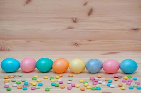 Eight easter eggs pastel colored on the wooden background Stock Photos