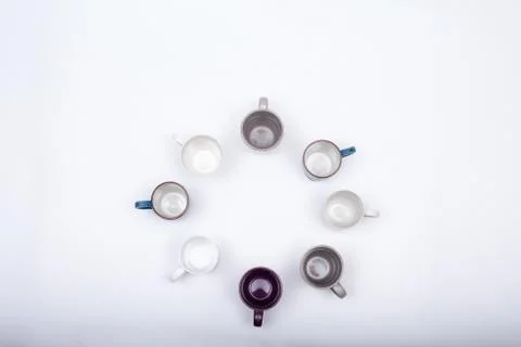Eight empty coffee cups arranged in round pattern, isolated on white backgrou Stock Photos