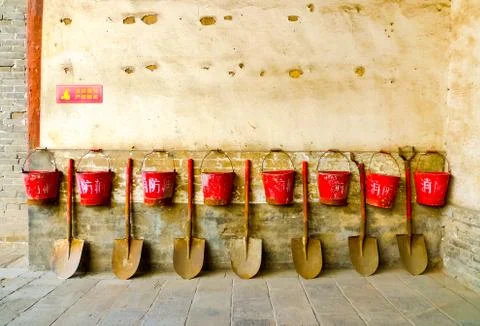 Eight fire buckets hung on a wall Stock Photos