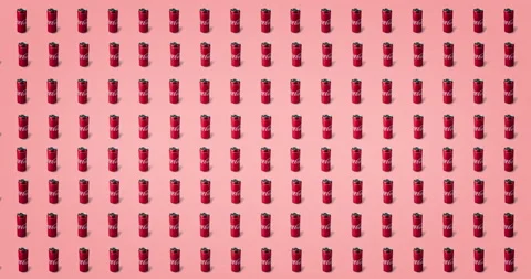 Eight lines of tin coca cola cans animated on a pink background Stock Footage 135736058