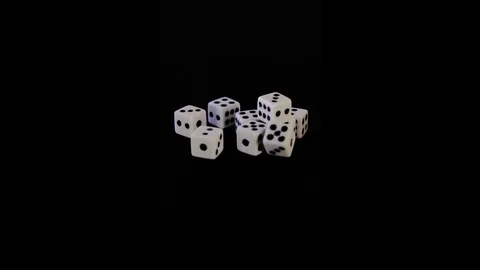 Eight white dice on a black background for the game. Bones lie on a black Stock Footage 129870845