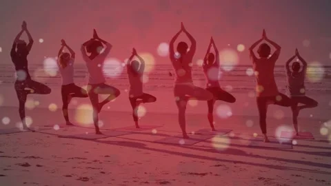 Eight women holding tree pose on beach, balancing, adjusting for wellness with Stock Footage 335465288
