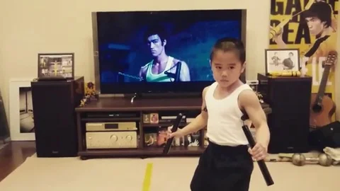 Eight-year-old mini Bruce Lee masters scene from Enter the Dragon Stock Footage 106306830