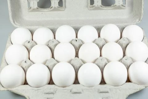 Eighteen eggs in their cardboard crate waiting to be used by the cook. Stock Photos