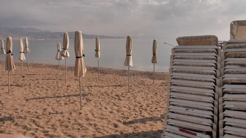 Eilat beach. Sunset. Medium shot of the empty beach loungers one on another and Video stock 125898425