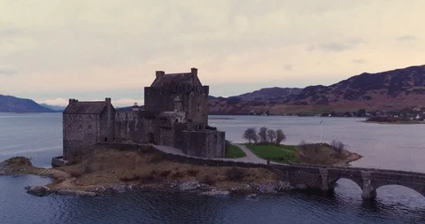 Eilean Donan Castle day time with Scottish Flag flying drone aerial 4K Stock Footage 104584261