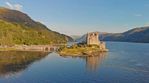 Eilean Donan Castle front view aerial shot before sunset Stock Footage 125776387
