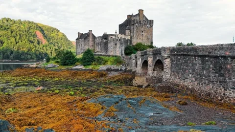 Eilean Donan Castle stands majestically on the coast of Scotland Stock Footage 314001048