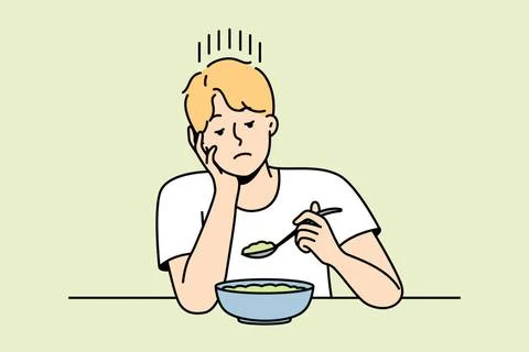 Ein Mann ohne Appetit sieht sich ein Gericht für magere Kost an. Guy witho.. 스톡 사진