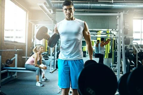 Either you do it, or you dont. a young man working out alone in the gym. Stock Photos