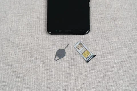 Eject tool and Sim card tray on 2 sims Stock Photos