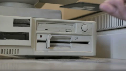 Ejecting old-style 3.5 and 5.25 Inch floppy disk from retro computer Stock Footage 157961367