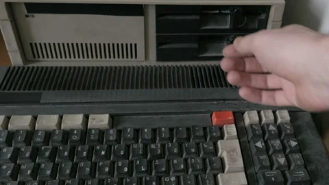 Ejecting old-style 5.25 Inch floppy disk from retro computer Stock Footage 91313197