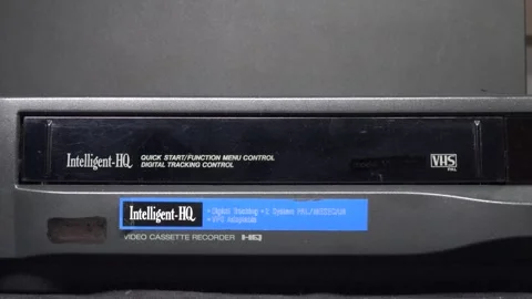 Ejecting the VHS tape from the player with a close-up on the door Stock Footage 315271915