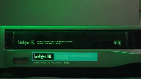 Ejecting the VHS tape from the player with a view on the door with light effects Stock Footage 315271861