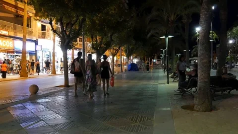 El Arenal Mallorca Spain: Tourists walking in the harbour area in the night Stock Footage