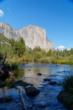 El Capitan's imposing granite face rises majestically over the Merced River.. Stock Photos