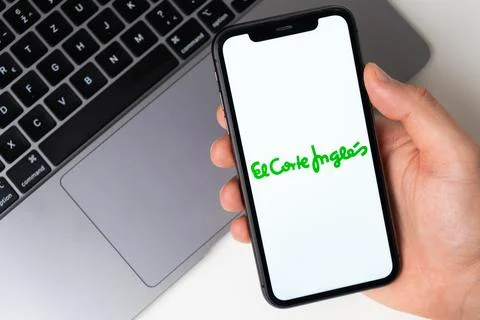 El Corte Ingles the application is open in the smartphone. The man is holding a Stock Photos