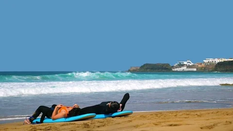 El Cotillo, beach, surfer relaxing and watching the waves on a sunny day Video stock 117472784