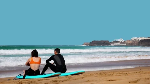 El Cotillo, beach, surfer relaxing and watching the waves on a sunny day Video stock 117472851