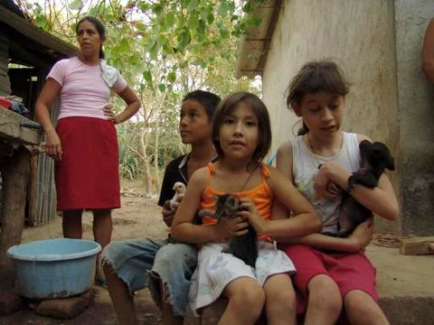 El salvador children kids on farm with puppies Stock Photos