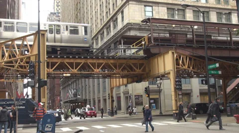 El train Chicago arrive station rail track subway railroad traffic street cross  Stock Footage