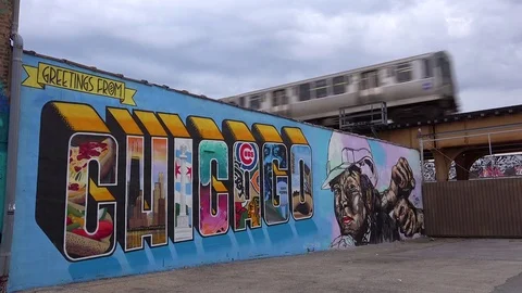 An El train passes a large mural painted Chicago. Stock Footage 79500073