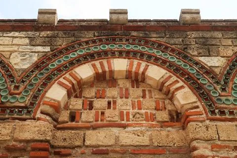 Elaborate patterns out of bricks and tiles decorate the facade of the Church  Stock Photos