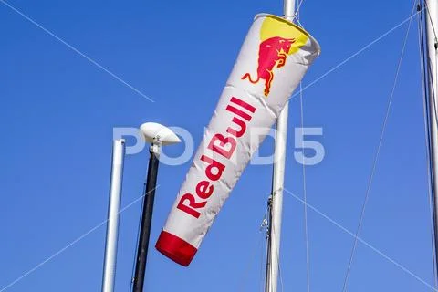 Elba island , Italy - July 16, 2018: Windsurfer .A racer man using the sail to Stock Photos