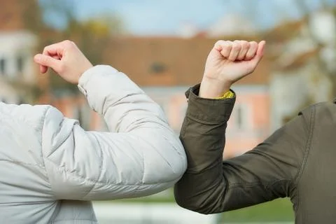 Elbow bumping. Elbow greeting to avoid the spread of coronavirus (COVID-19). Stock Photos