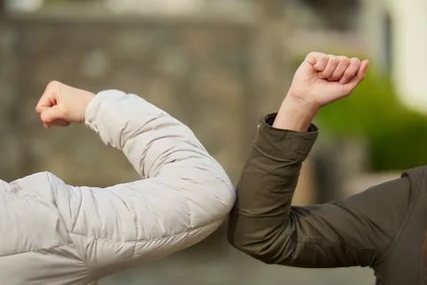 Elbow bumping. Elbow greeting to avoid the spread of coronavirus (COVID-19). Stock Photos