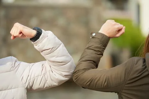 Elbow bumping. Elbow greeting to avoid the spread of coronavirus (COVID-19). Stock Photos