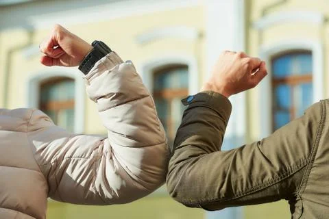 Elbow bumping. Elbow greeting to avoid the spread of coronavirus (COVID-19). Stock Photos