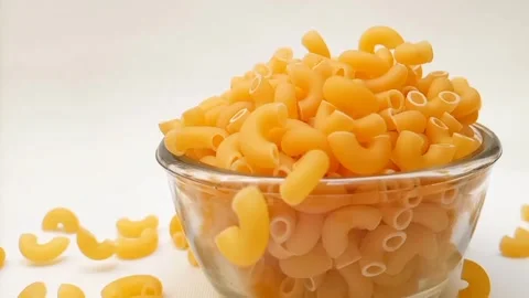 Elbow Macaroni Pasta Dropping in Glass Bowl on White Background, Uncooked Elbow  스톡 동영상 333667472