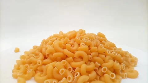 Elbow Macaroni Pasta Dropping on White Background, Uncooked Elbow Macaroni Pasta 스톡 동영상 333667473