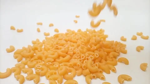 Elbow Macaroni Pasta Dropping on White Background, Uncooked Elbow Macaroni Pasta Stock-Footage 333667490