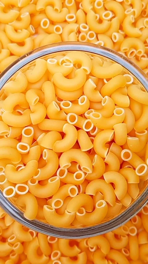 Elbow Macaroni Pasta Rotating Background, Uncooked Elbow Macaroni Pasta Vídeos de archivo 334368498