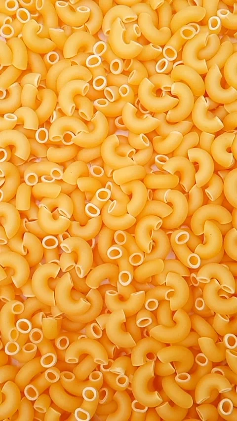 Elbow Macaroni Pasta Rotating Background, Uncooked Elbow Macaroni Pasta Видео 334368525