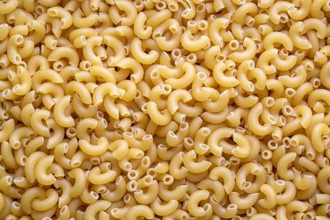 Elbow macaroni texture for background. Stock Photos