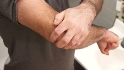 Elbow Pain Man Suffering Trying to Bend his Elbow Closeup Stock Footage 146560979