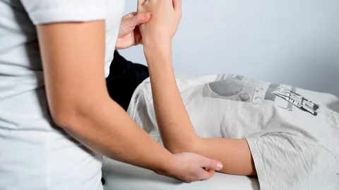 Elbow physiotherapy for a boy Stock Footage 98791098