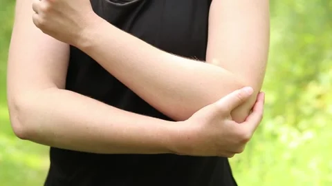 Elbow problem during training. Girl in sportswear massaging her bruised arm 스톡 동영상 311529470